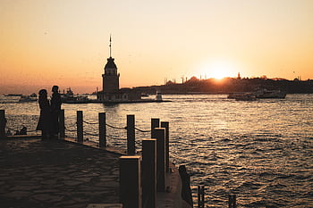 Romantic silhouette at sunset by the iconic Maiden's Tower in İstanbul. HD wallpaper