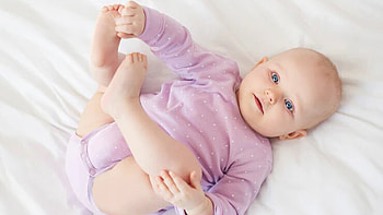 Nice Looking Little Cute Baby Is Lying Down On White Cloth Wearing Light Purple Dress Cute HD wallpaper