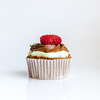 A delightful chocolate cupcake topped with raspberry and creamy frosting, perfect for dessert lovers. HD phone wallpaper