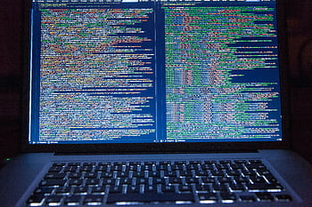 Laptop displaying source code with dual screens for software development. HD wallpaper