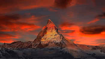 Breathtaking view of the Matterhorn at sunset with vibrant red and orange skies. HD wallpaper