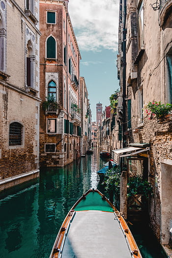 Captivating view of a traditional Venetian canal surrounded by historic buildings, perfect for travel enthusiasts. HD phone wallpaper