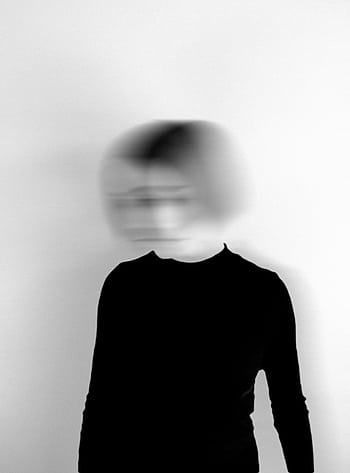 Black and white silhouette of a woman with a blurred face, creating an artistic and mysterious effect. HD phone wallpaper
